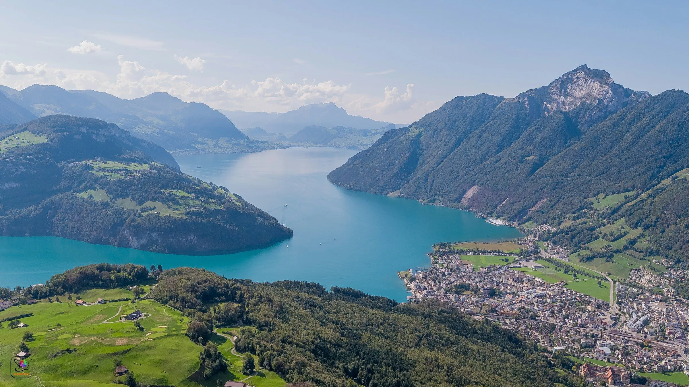 View over Brunnen and Lake Uri with valley floor, settlement and Prealps